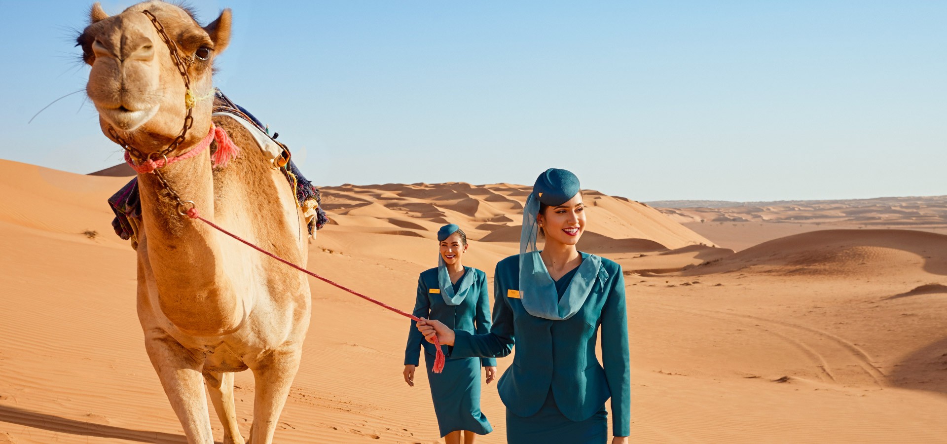 Oman Air Crew in Desert handling Camel